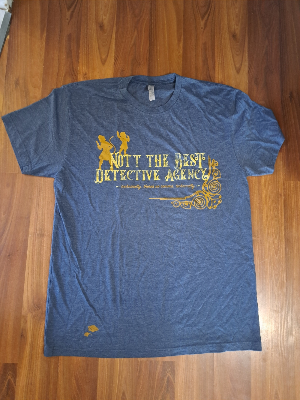 Next Level Apparel Heather Blue Tee with Gold Detective Graphic